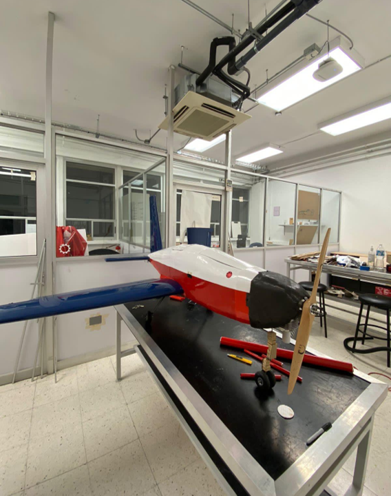 Finished red, white, and blue scale aircraft prototype on a lab table
